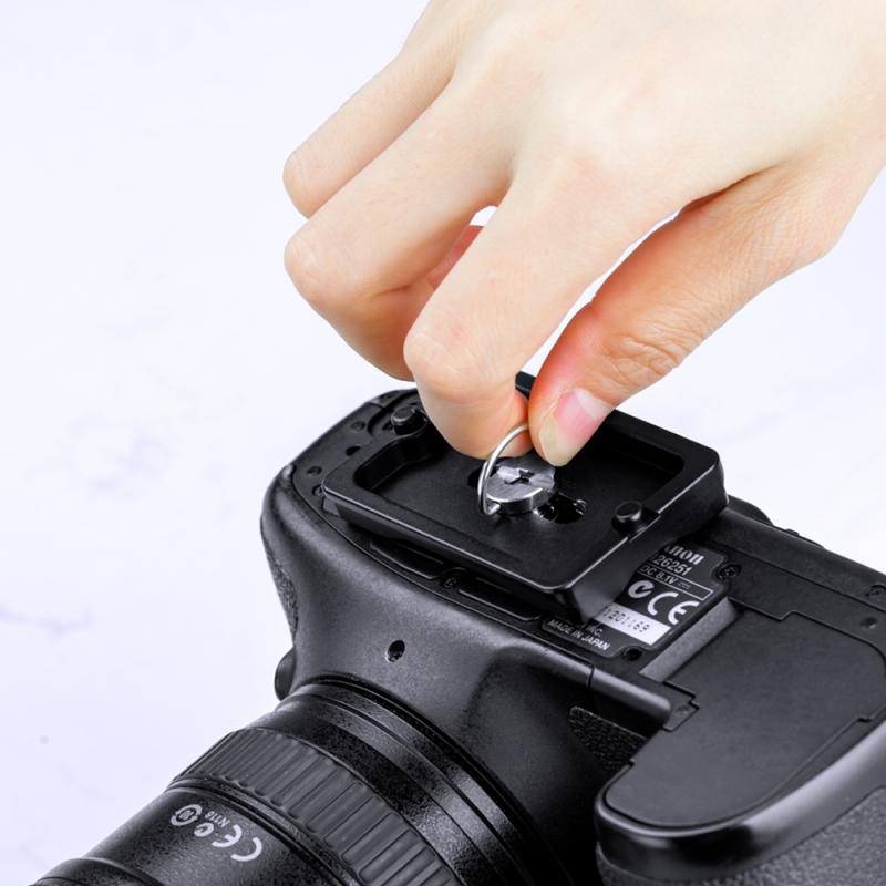 Attaching a camera to a tripod's quick release plate.